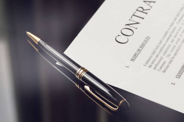 TTA contract drafting — pen on agreement document